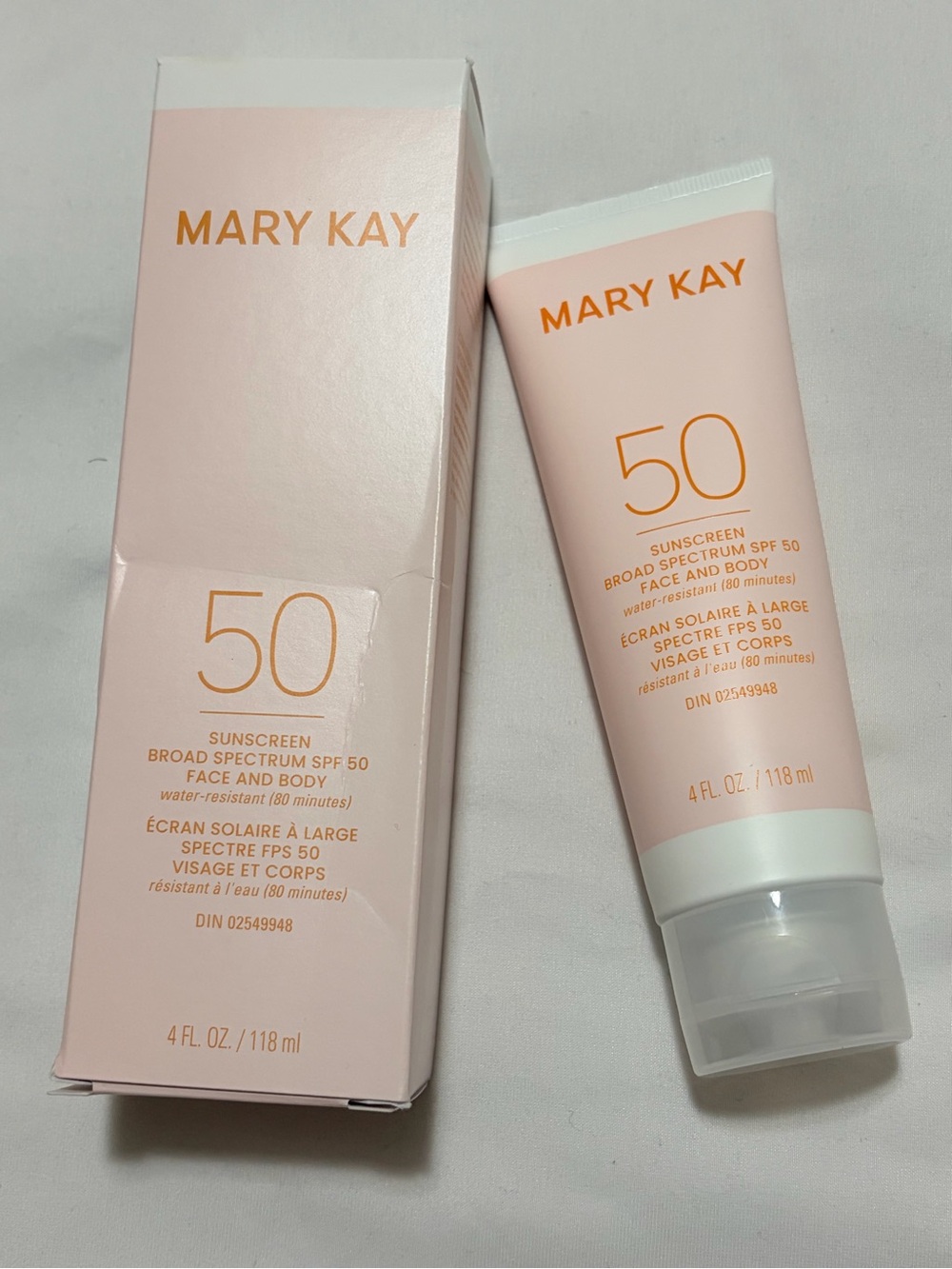 Mary Kay SPF 50 Broad Spectrum Sunscreen Tube and Box - Soft Pink with Gold Text